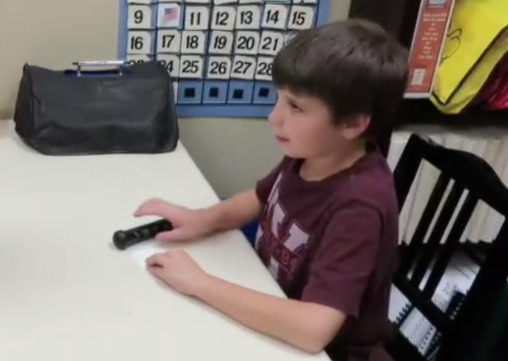 A young braille student uses the PenFriend