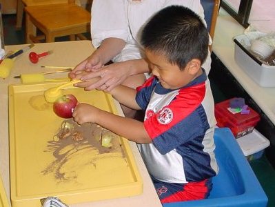 Young boy playing in sand tray