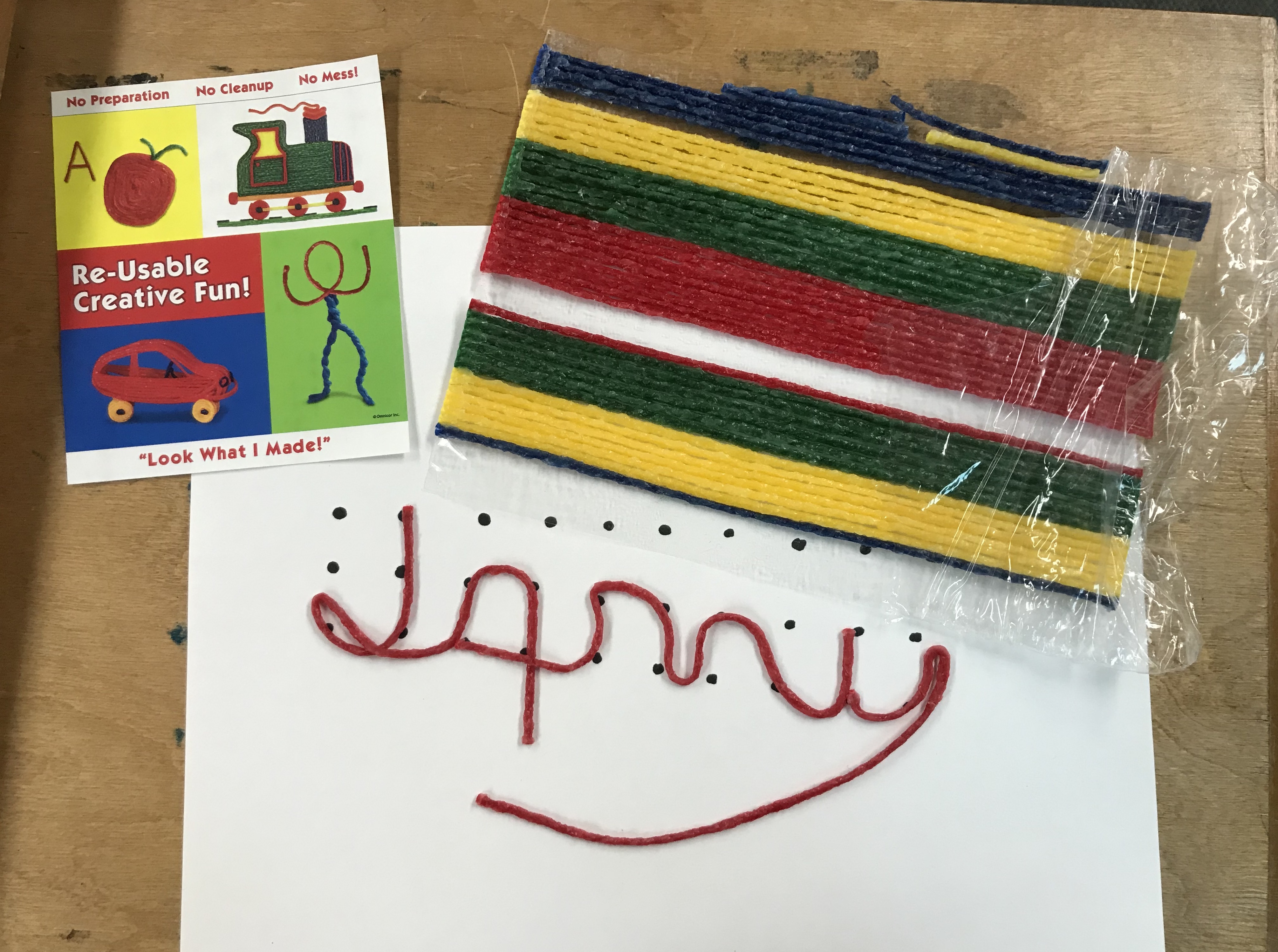 Signature with Wikki Stix, along with packets of Wikki Stix