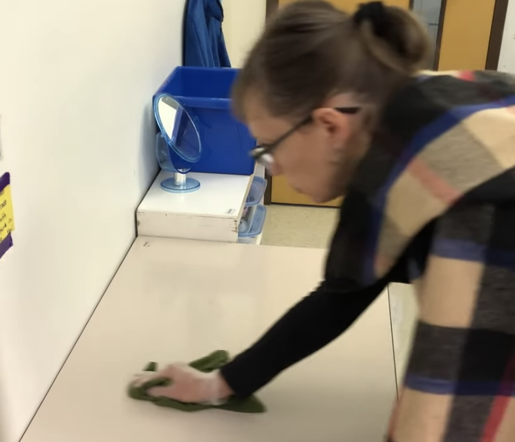 A woman wiping a table