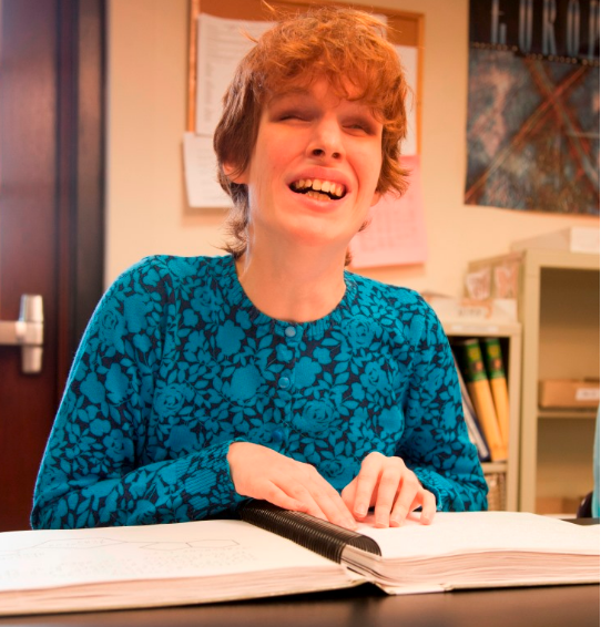 Young woman reading braille